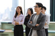© feeling lucky - Collaborative process of young asian business people team working together discussing, researching, brainstorming and planning while crossed arms in business office building and city background