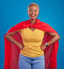 Wall Mural - Black woman, superhero cape and portrait in studio, blue background and fashion. Happy female model, superwoman and brave cosplay character of justice, smile and pride of girl power, proud and strong