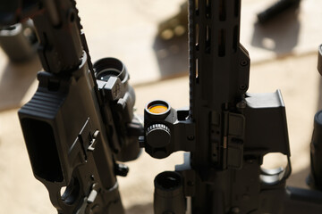 Canvas Print - Modern American assault rifles on a weapon stand at the shooting range. Black carbine guns in close up