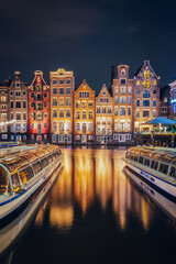 Wall Mural - Canals in Amsterdam - the capital of the Netherlands in a night scenery. The huge amount of colors adds a beautiful look to this architecture.