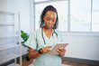 © Meeko Media - Portrait of a young Black female doctor, using digital tablet, eHealth