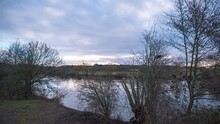 A Stationary Timelapse Shot Of The River Little Ouse Riverbank In The East Of England During Sunrise.