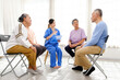 © artitwpd - The caregiver therapist sits with a group of Asian senior people in a circle for checking physical and mental health in a group elderly therapy session. The nursing home facilitates a support group