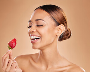 Poster - Beauty, skincare or happy woman with strawberry in studio on beige background for healthy nutrition or clean diet. Smile, face or funny girl model laughing or marketing natural fruits for wellness