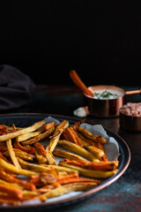 Wall Mural - Healthy homemade oven baked sweet potato and carrot fries served with yogurt and green onion sauce. Low calorie vegetarian snack