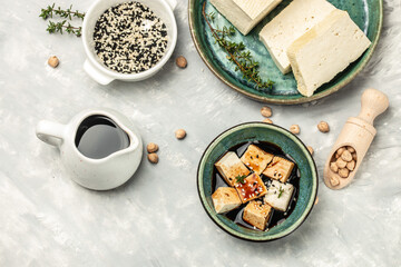 Canvas Print - teriyaki tofu cubes on a light background. banner, menu, recipe place for text, top view