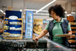 © Drazen - Female store manager inspecting food while working in refrigerated compartment at supermarket.