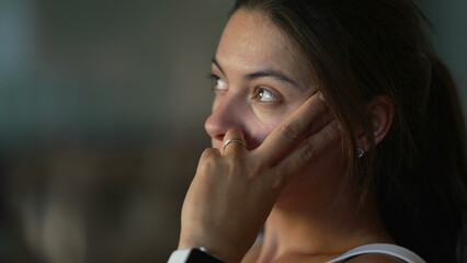 Contemplative woman thinking deeply at apartment balcony. Pensive female person in her 30s with thoughtful emotion. closeup face serious expression