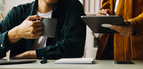 Close up ux developer and ui designer use augmented reality brainstorming about mobile app interface wireframe design on desk at modern office.Creative digital development agency