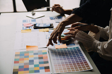 Close up ux developer and ui designer use augmented reality brainstorming about mobile app interface wireframe design on desk at modern office.Creative digital development agency