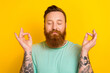© deagreez - Portrait of calm kind candid man wear trendy green clothes enjoy free time yoga practice isolated on yellow color background