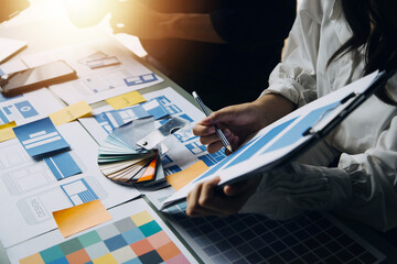 Close up ux developer and ui designer use augmented reality brainstorming about mobile app interface wireframe design on desk at modern office.Creative digital development agency