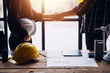 © ARMMY PICCA - Construction and structure concept of engineer working drawing on blueprint meeting for project working with partner on model building and engineering tools in working site, construction concept