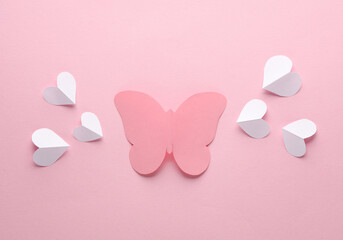 Wall Mural - Paper-cut butterfly with hearts on a pink background. Love concept