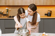 © inna717 - happy family in the kitchen. mother and daughter prepare dough, bake cookies, Easter cake.