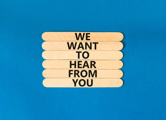 Wall Mural - Support symbol. Concept words We want to hear from you on wooden stick. Beautiful blue table blue background. Business support we want to hear from you concept. Copy space.