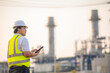 © reewungjunerr - Asian man petrochemical engineer working at oil and gas refinery plant industry factory,The people worker man engineer work control at power plant energy industry manufacturing
