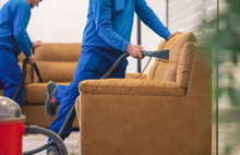 Machine upholstery cleaning.Cleaning furniture.Two workers cleaning upholstery