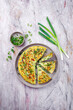 © HLPhoto - Traditional Italian vegetable frittata with zucchini, spring onion and cheese served as top view on Nordic design plate with text space