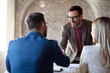 © Novak - Business people handshaking at meeting in office