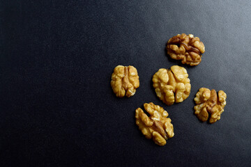 Canvas Print - Top view of walnut without shell on dark background
