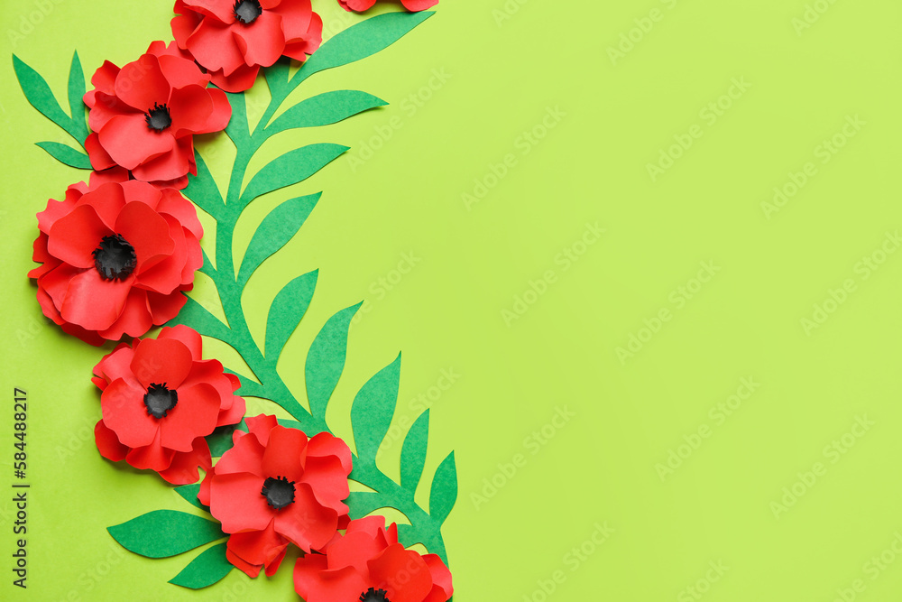Paper poppy flowers with leaves on green background