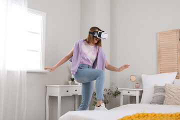 Wall Mural - Pretty young woman in VR glasses in bedroom