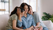 © ChayTee - Happy time May Mother day cuddle hug care love face to face kiss cheek to mature mum. Asia middle aged old mom adult people smile enjoy receive gift flower from young child sitting at home sofa relax.