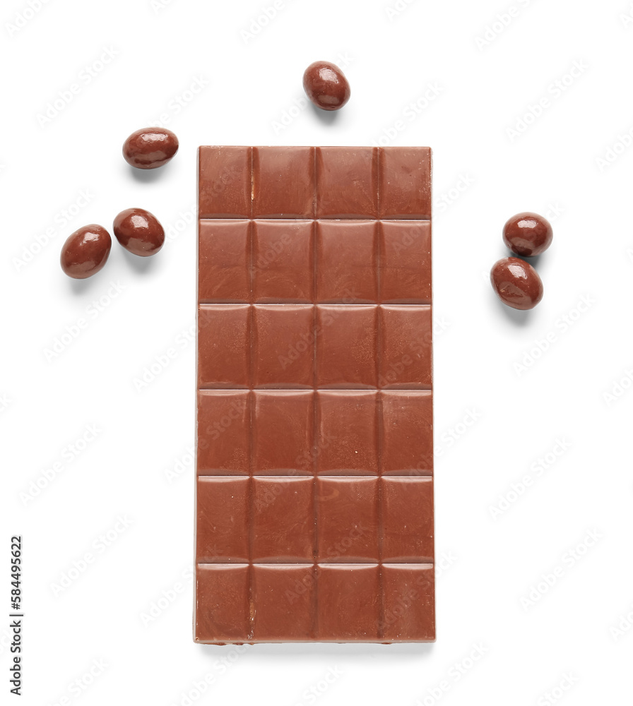 Sweet chocolate bar and candies on white background