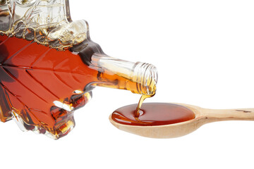 pouring of tasty maple syrup from bottle into spoon on white background, closeup