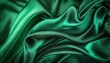 Texture of green silk fabric. Beautiful emerald green soft silk fabric