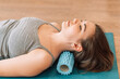 © Anastassiya  - Girl kneading her neck with foam roller
