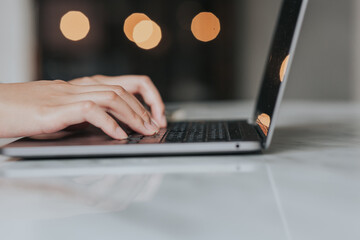 Wall Mural - Female hands typing on laptop keyboard.