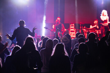 Crowd at concert and blurred stage lights.