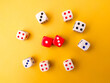 © Mohd Azrin - Top view Colored dice on a yellow background.