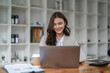 © Natee Meepian - Portrait asian woman working with laptop in her office. business financial concept.