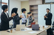 © Queenmoonlite Studio - Young business partners applauding to manager after listening to presentation report at office meeting room