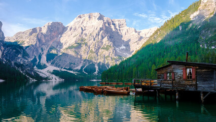 Lago di Braies Braies lake, Pragser wildsee at sunrise. Trentino Alto Adidge, Dolomites mountains, South Tyrol, Italy, Europe. Boats in the morning at the lake