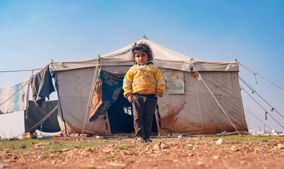 Portrait of refugee children living in the camp. The tragic humanitarian conditions of Syrian refugees