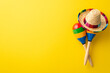 © ActionGP - Top view photo of two colorful striped maracas with mexican hat isolated vibrant yellow backdrop with space for text