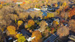 © trongnguyen - Aerial view Penfield small town USA with local business, church building, residential houses by colorful fall foliage, Upstate New York, America