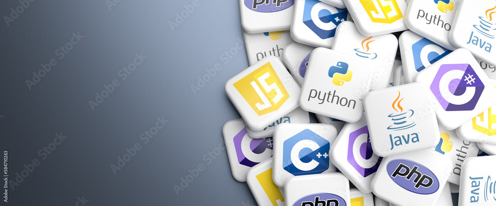 Logos of the main programming languages Python, Java, Javascript, C#, C++ and PHP on a heap on a table. Web banner format, copy space
