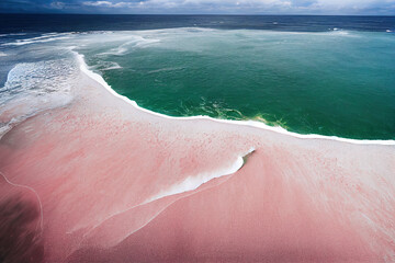 Wall Mural - Spectacular top view from drone photo of beautiful pink beach with relaxing sunlight, sea water waves pounding the sand at the shore. Calmness and refreshing beach scenery.