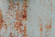 Rusty metal painted background. Rust spots and streaks on stained metal surface. Grunge industrial colored steel texture. Scratched corroded aged damaged backdrop with rustic vintage worn details.
