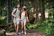 © luckybusiness - A young happy couple is walking the forest path on the mountain. Trip, nature, hiking