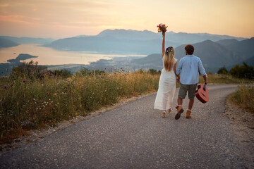 Wall Mural - Young hipster man and woman on road trip.wedding lovely  couple at nature