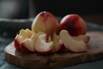 Wall Mural - ripe nectarines on wood board with natural lighting