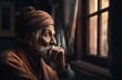Old hindu man sits near the window
