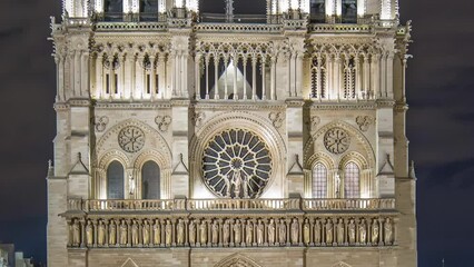 Wall Mural - Night View of illuminated Notre Dame de Paris timelapse, France and square in front of the cathedral with people. Front view of facade