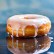 A mouthwatering photograph of a perfectly glazed donut, featuring a soft, fluffy texture and a glossy, sugar-sweet icing that invites indulgence